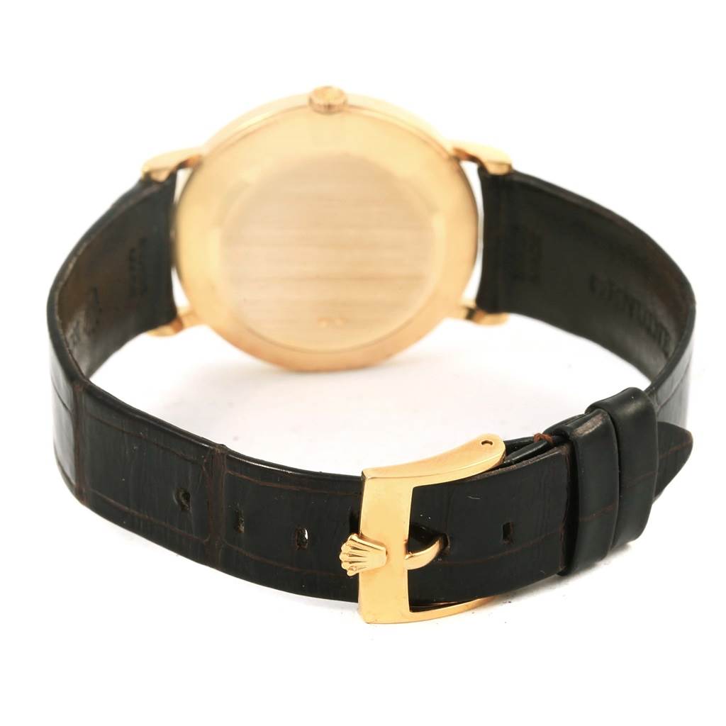 This image shows the back of the Rolex Cellini 5112 Men
s Beige Dial 5112 Men
s Beige Dial watch and its leather strap with a Rolex-branded clasp.
