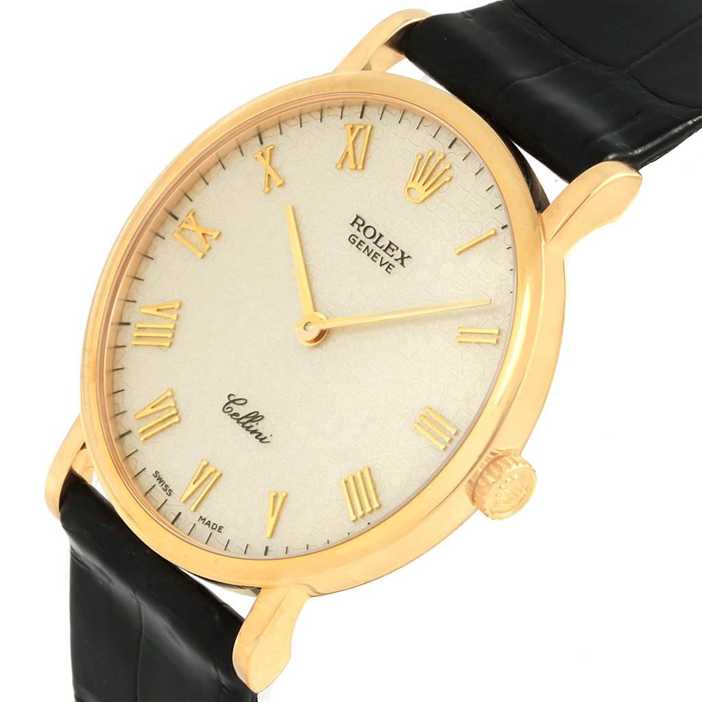 The image shows a close-up side angle of a Rolex Cellini 5112 Men's Yellow Gold Beige Dial 5112 Men's Yellow Gold Beige Dial watch, highlighting its face, golden case, crown, and black leather strap.