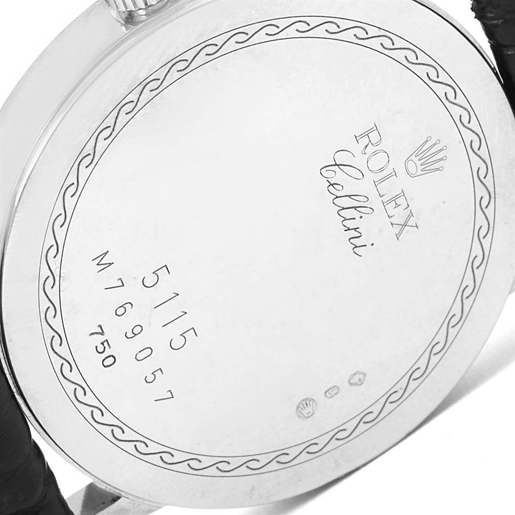 The image shows the back case of a Rolex Cellini 5115 Men
s White Gold Silver Dial 5115 Men
s White Gold Silver Dial watch with its engraved details and leather strap partially visible.