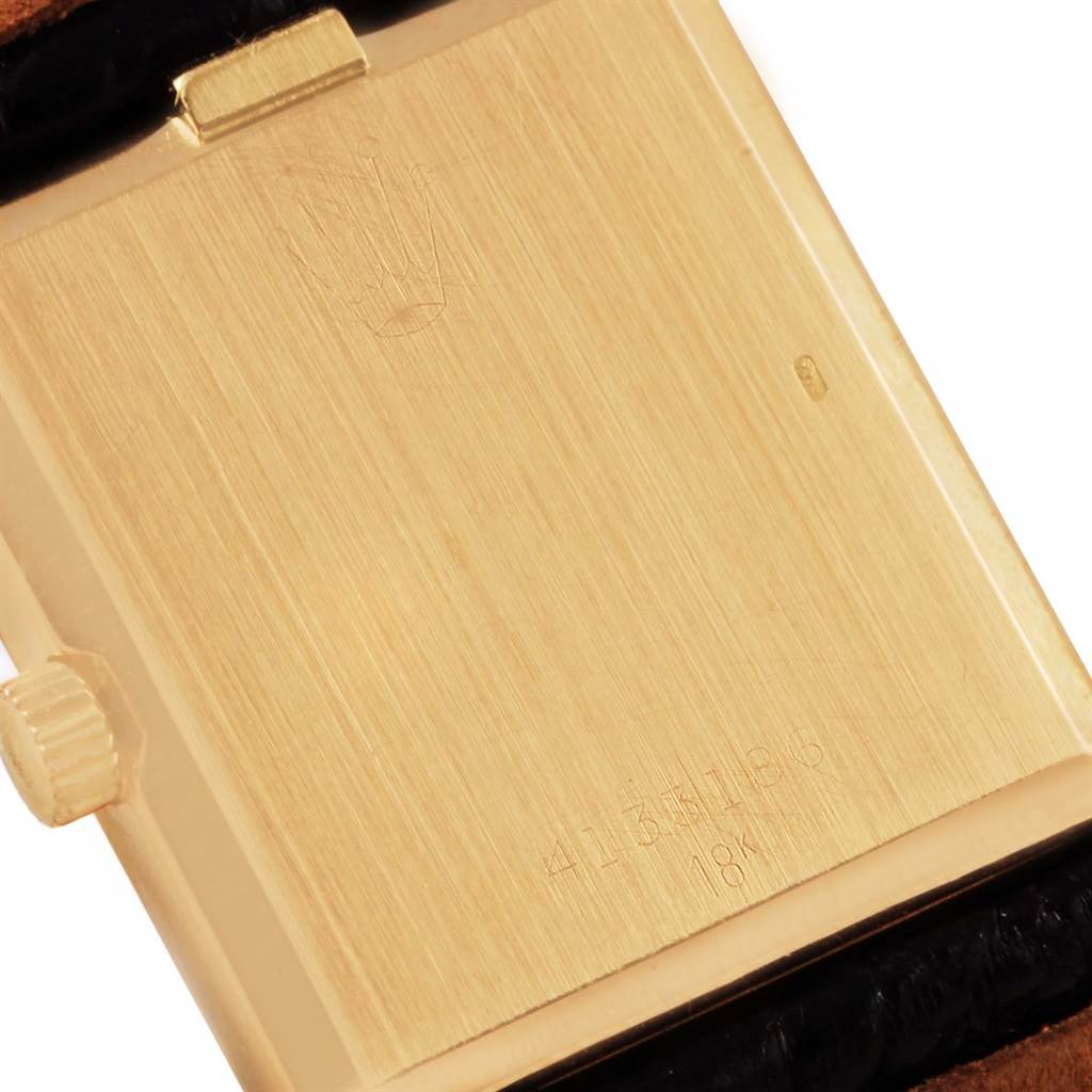 The image shows the back case of a Rolex Cellini 4027 Men
s Yellow Gold Champagne Dial 4027 Men
s Yellow Gold Champagne Dial watch, highlighting the crown and engravings.