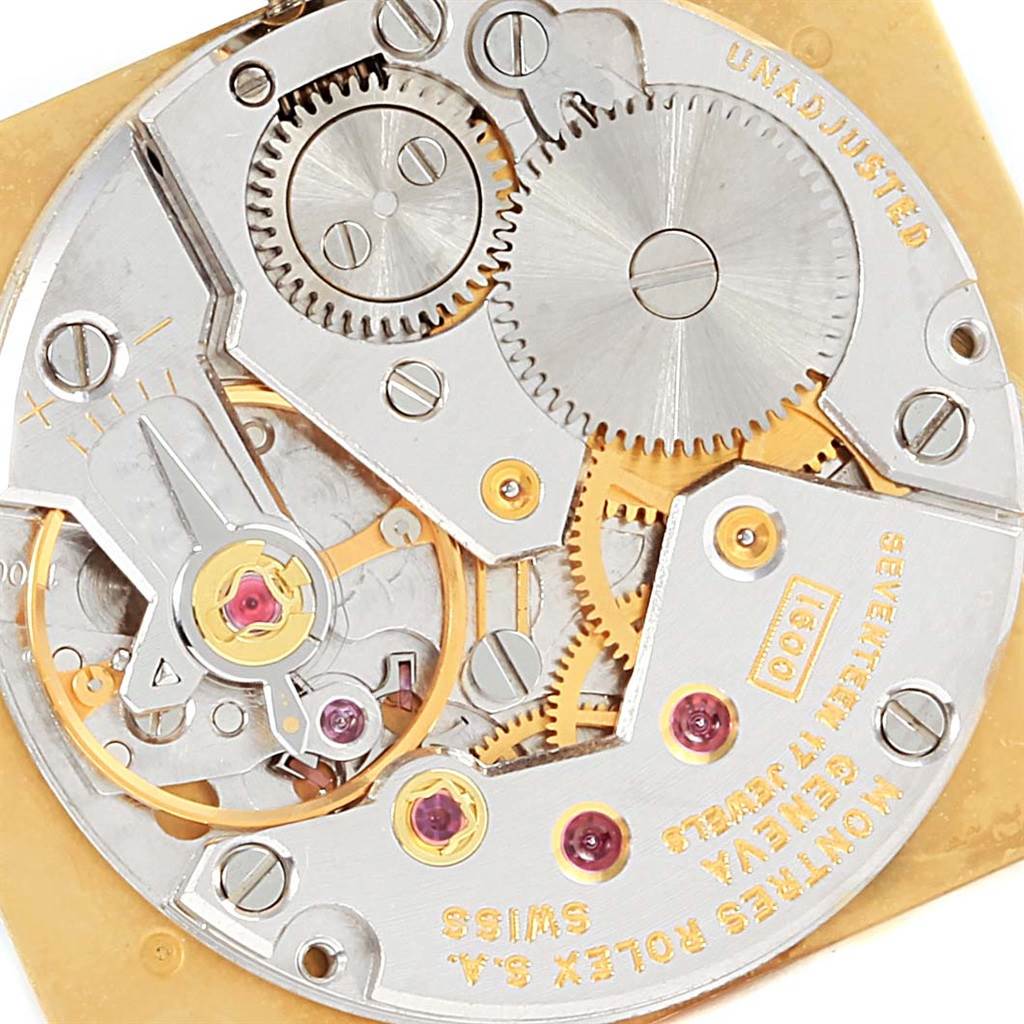 The image shows a close-up of the internal mechanism of a Rolex Cellini 4027 Men
s Yellow Gold Champagne Dial 4027 Men
s Yellow Gold Champagne Dial watch, highlighting gears and intricate components.
