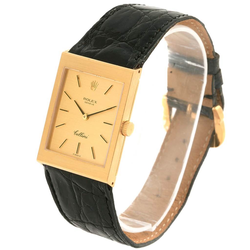 The Rolex Cellini 4027 Men
s Yellow Gold Champagne Dial 4027 Men
s Yellow Gold Champagne Dial watch is shown at a slight angle, displaying its rectangular gold face and black leather strap.