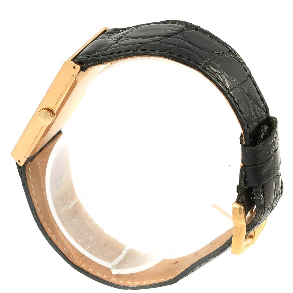 The image shows a side view of a Rolex Cellini 4027 Men
s Yellow Gold Champagne Dial 4027 Men
s Yellow Gold Champagne Dial watch focusing on the case, crown, and black leather strap with a buckle.