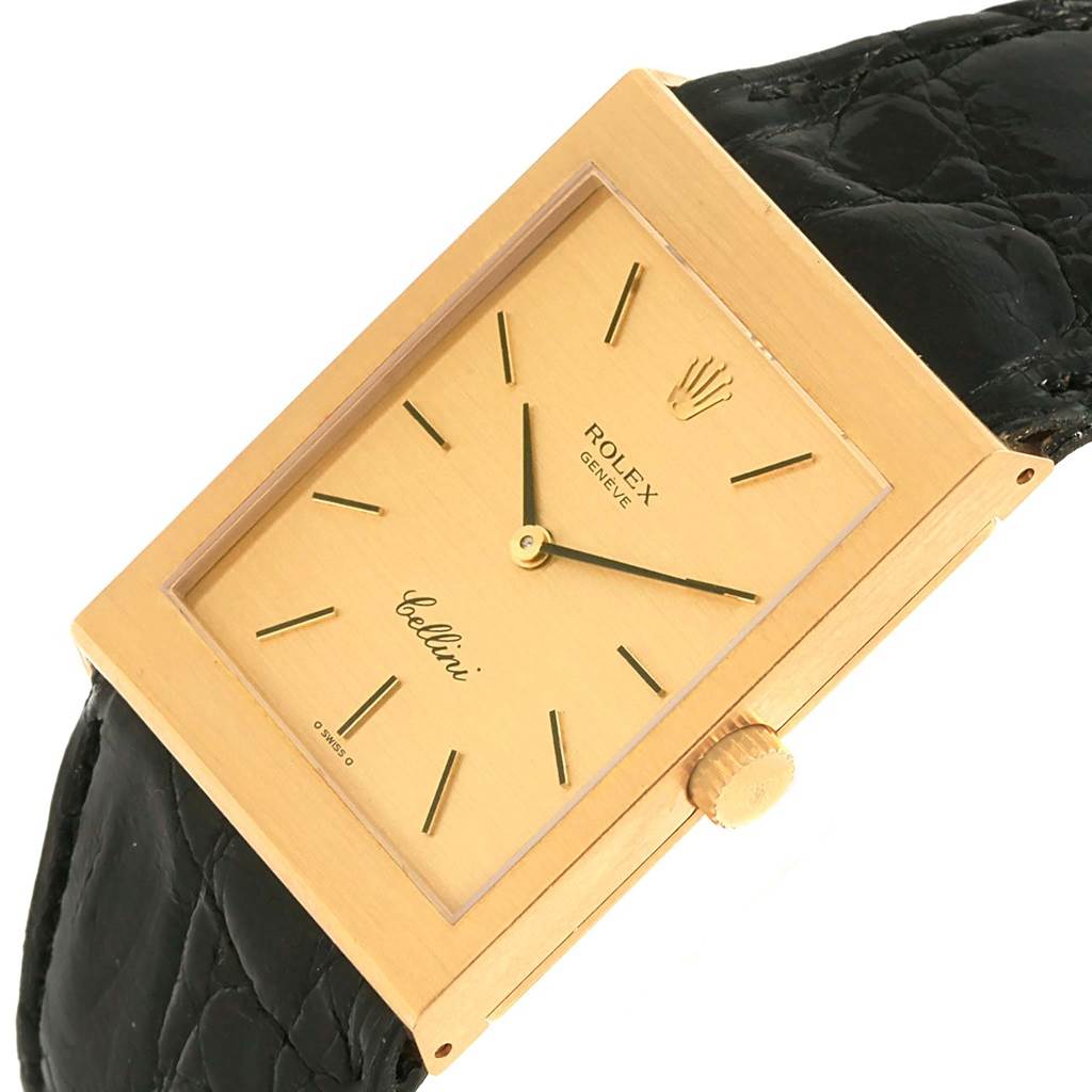 The Rolex Cellini 4027 Men
s Yellow Gold Champagne Dial 4027 Men
s Yellow Gold Champagne Dial watch is shown at a slight angle, displaying its rectangular gold case, crown, black leather strap, and gold dial.