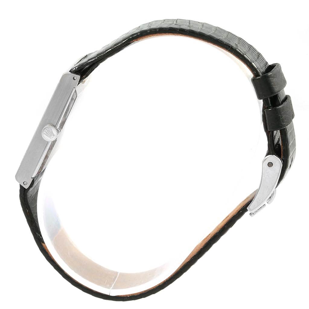 The Rolex Cellini 4014 Men's White Gold Silver Dial 4014 Men's White Gold Silver Dial watch is shown from a side angle, highlighting its black strap and crown.