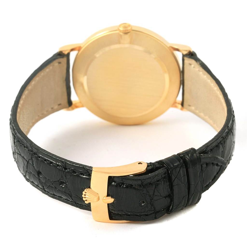 This image shows the back view of the Rolex Cellini 5112 Yellow Gold White Dial 5112 Yellow Gold White Dial watch, highlighting its gold case and black leather strap with a gold clasp.