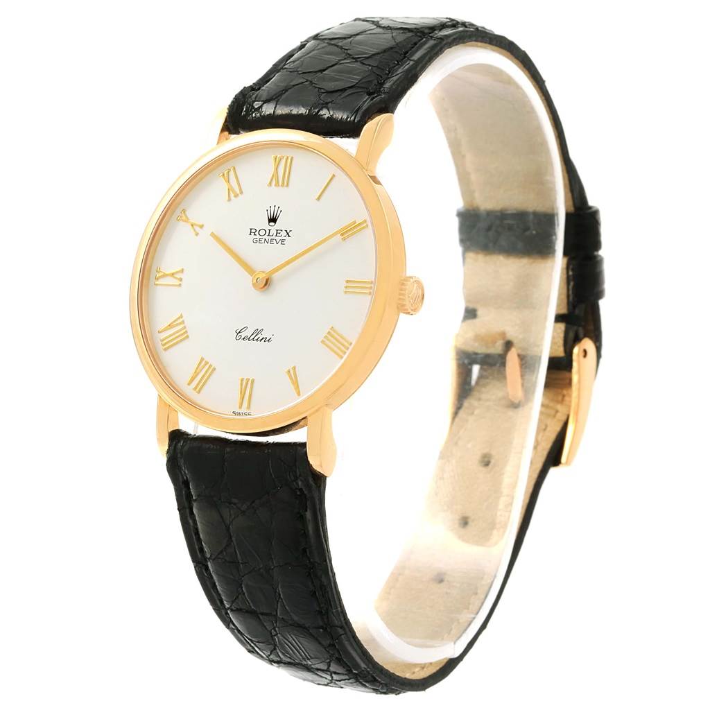 The image shows a side-angle view of a Rolex Cellini 5112 Yellow Gold White Dial 5112 Yellow Gold White Dial watch, highlighting its round dial, gold casing, and black leather strap.