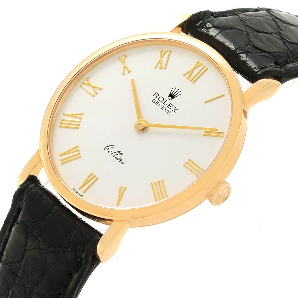 The Rolex Cellini 5112 Yellow Gold White Dial 5112 Yellow Gold White Dial watch is shown at an angled view, displaying its gold casing, white dial, Roman numerals, and black leather strap.