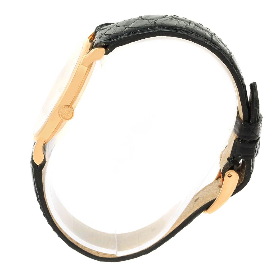 The image shows a side profile of a Rolex Cellini 5112 Yellow Gold White Dial 5112 Yellow Gold White Dial watch, highlighting the crown and black leather strap.