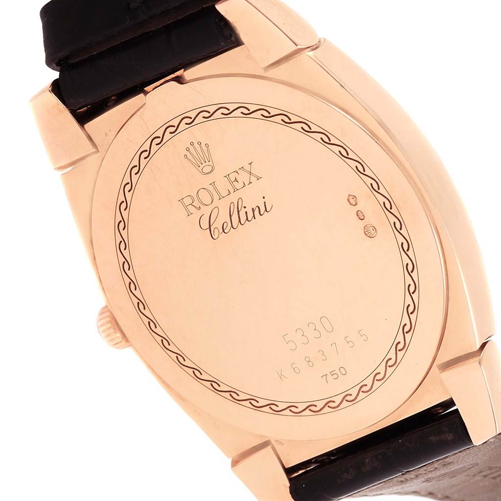 The image shows the back case of a Rolex Cellini 5330 Rose Gold Black Dial 5330 Rose Gold Black Dial watch, highlighting its engravings and leather strap attachments.