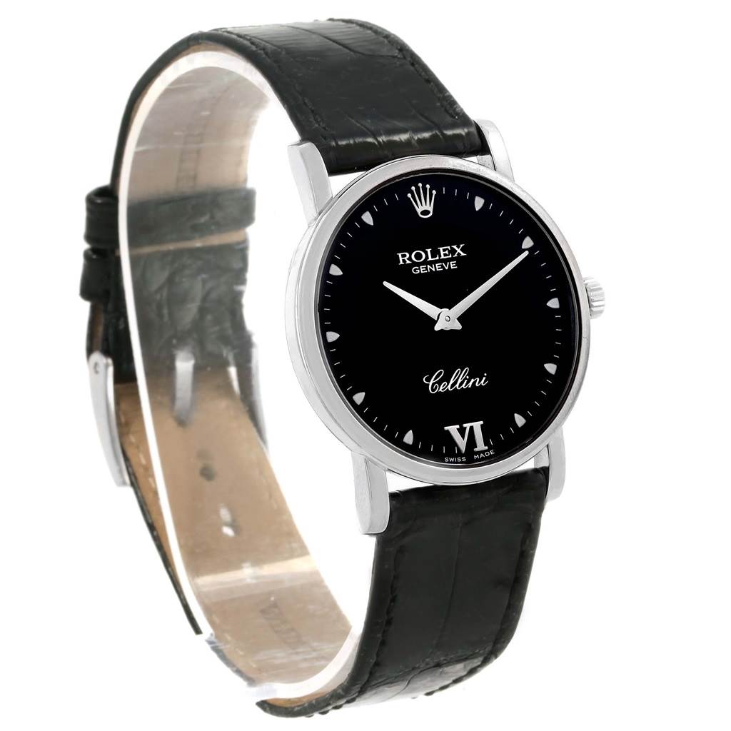 The image shows a Rolex Cellini 5115 White Gold Black Dial 5115 White Gold Black Dial watch from a diagonal angle, highlighting the black dial, silver casing, and black leather strap.