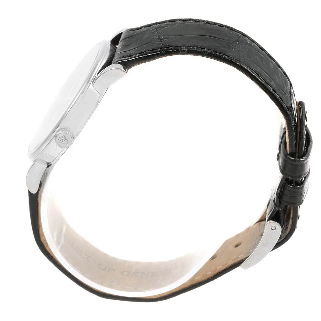 The image shows a side view of the Rolex Cellini 5115 White Gold Black Dial 5115 White Gold Black Dial watch, including its crown, case, and leather strap with a buckle.