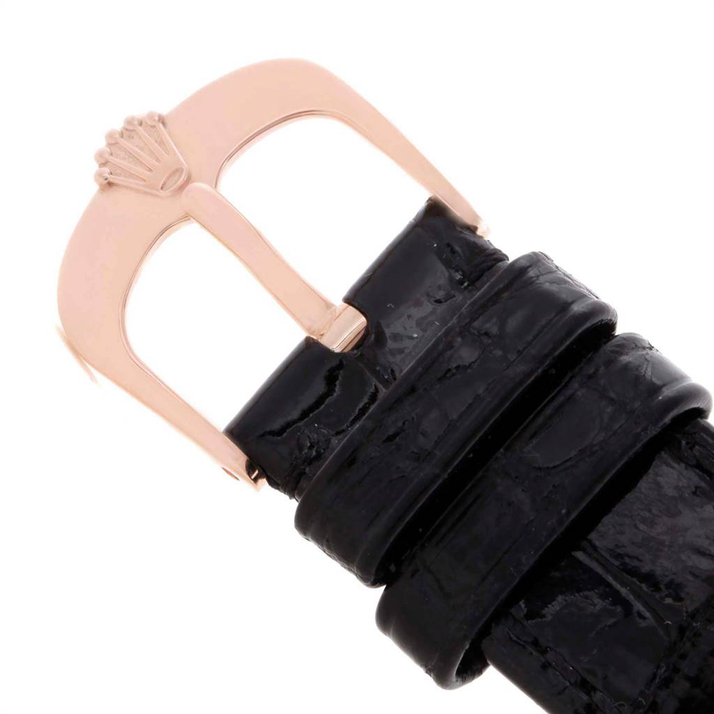 The image shows a close-up of a black leather strap with a gold buckle from the Rolex Cellini 50515 Men's Rose Gold Black Dial 50515 Men's Rose Gold Black Dial model.