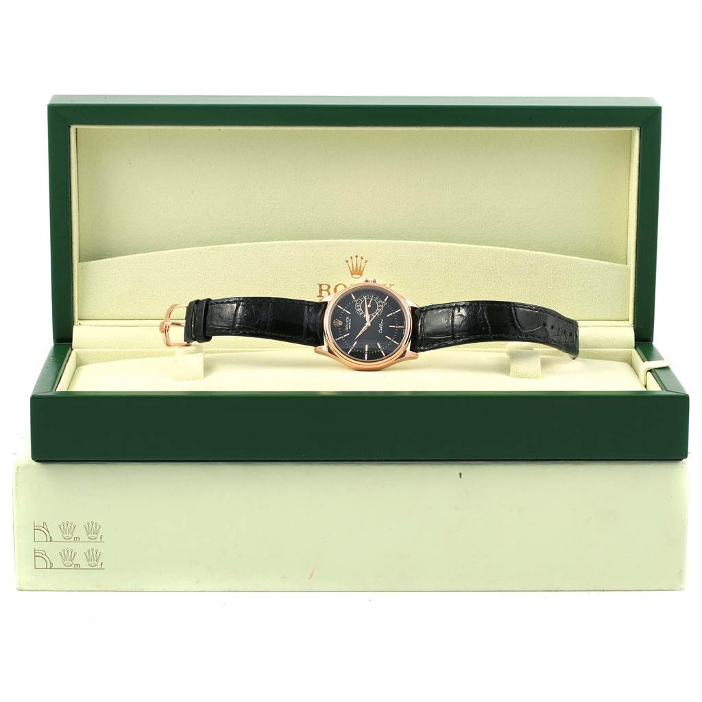 The Rolex Cellini 50515 Men's Rose Gold Black Dial 50515 Men's Rose Gold Black Dial watch is shown in its open box, displaying the face, case, and leather strap from a frontal angle.