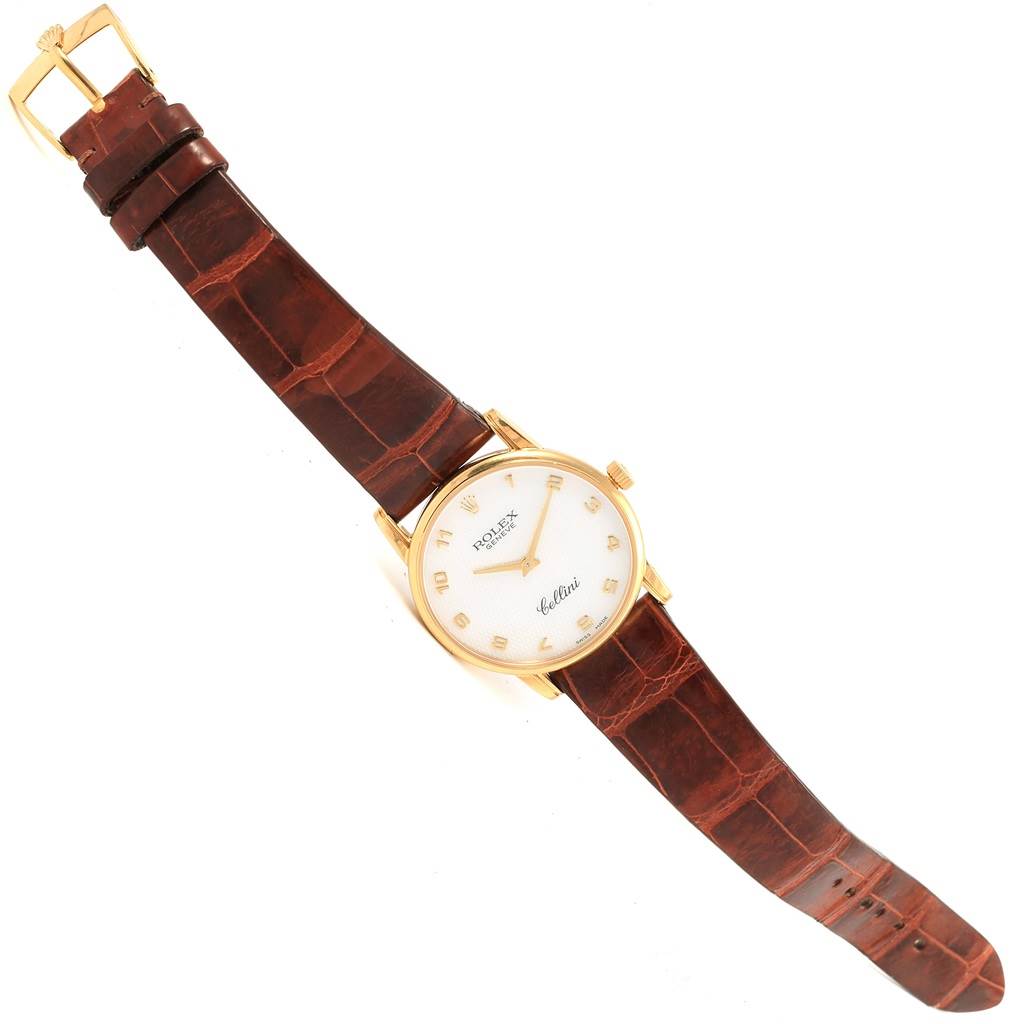 The Rolex Cellini 5116 Yellow Gold Mother of Pearl Dial 5116 Yellow Gold Mother of Pearl Dial watch is shown in a top-down angle, displaying its face, brown leather strap, and gold buckle.