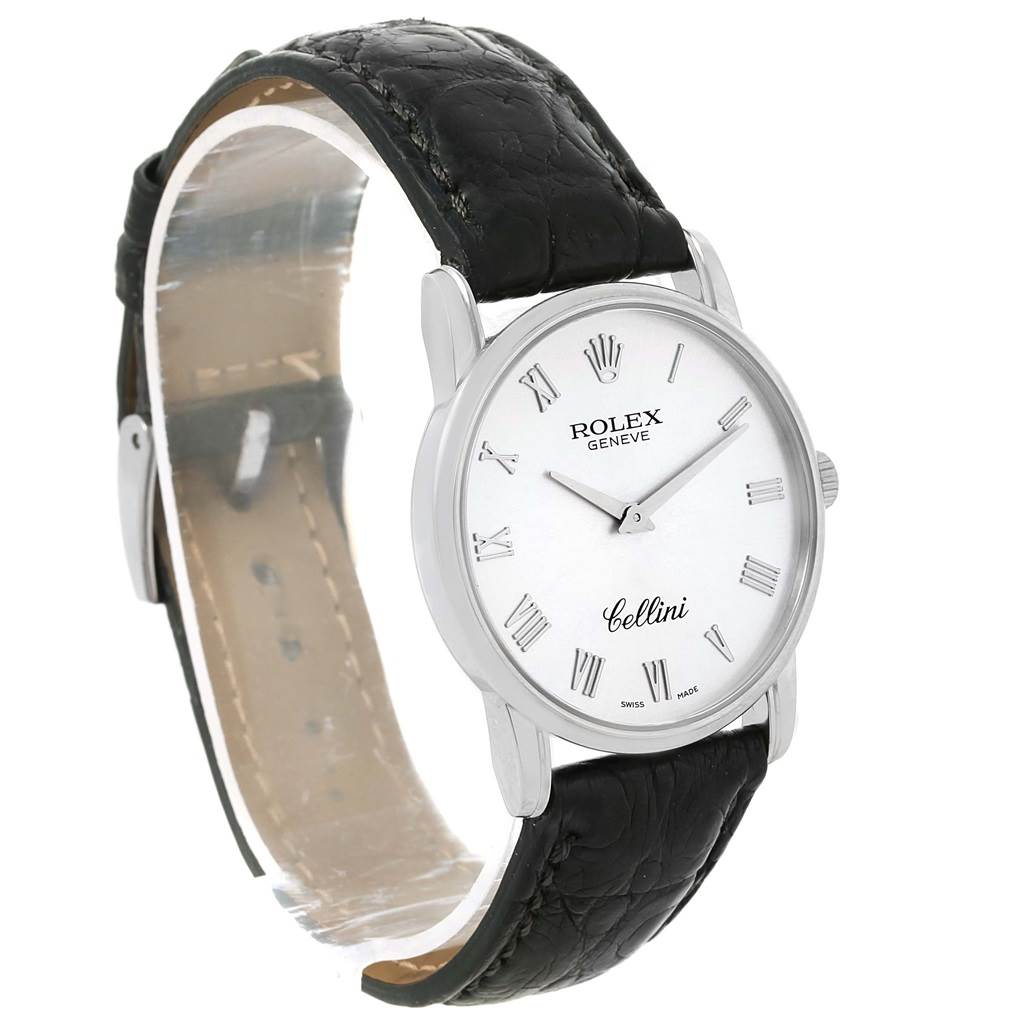 The image shows a Rolex Cellini 5116 Men
s White Gold Silver Dial 5116 Men
s White Gold Silver Dial watch at a three-quarter angle, highlighting the face, hands, Roman numerals, and black leather strap.