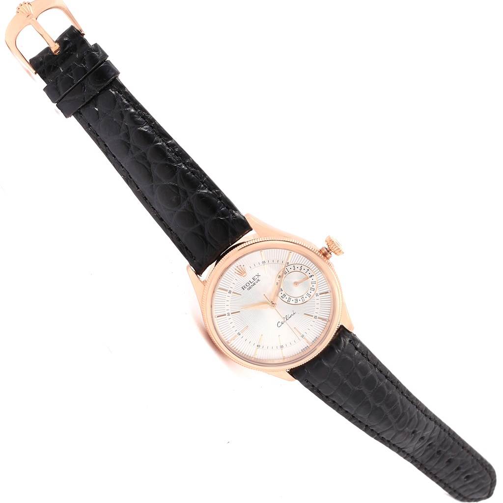 The Rolex Cellini 50515 Men's Rose Gold Silver Dial 50515 Men's Rose Gold Silver Dial watch is shown at an oblique angle, highlighting its dial, crown, and leather strap.