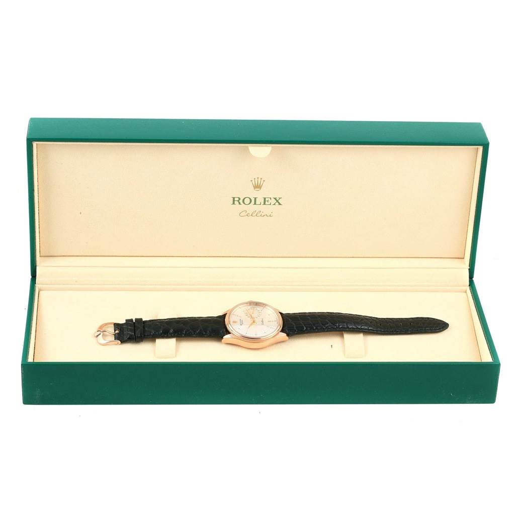 The image shows a Rolex Cellini 50515 Men's Rose Gold Silver Dial 50515 Men's Rose Gold Silver Dial watch with a black leather strap, placed inside an open green and cream-colored box.
