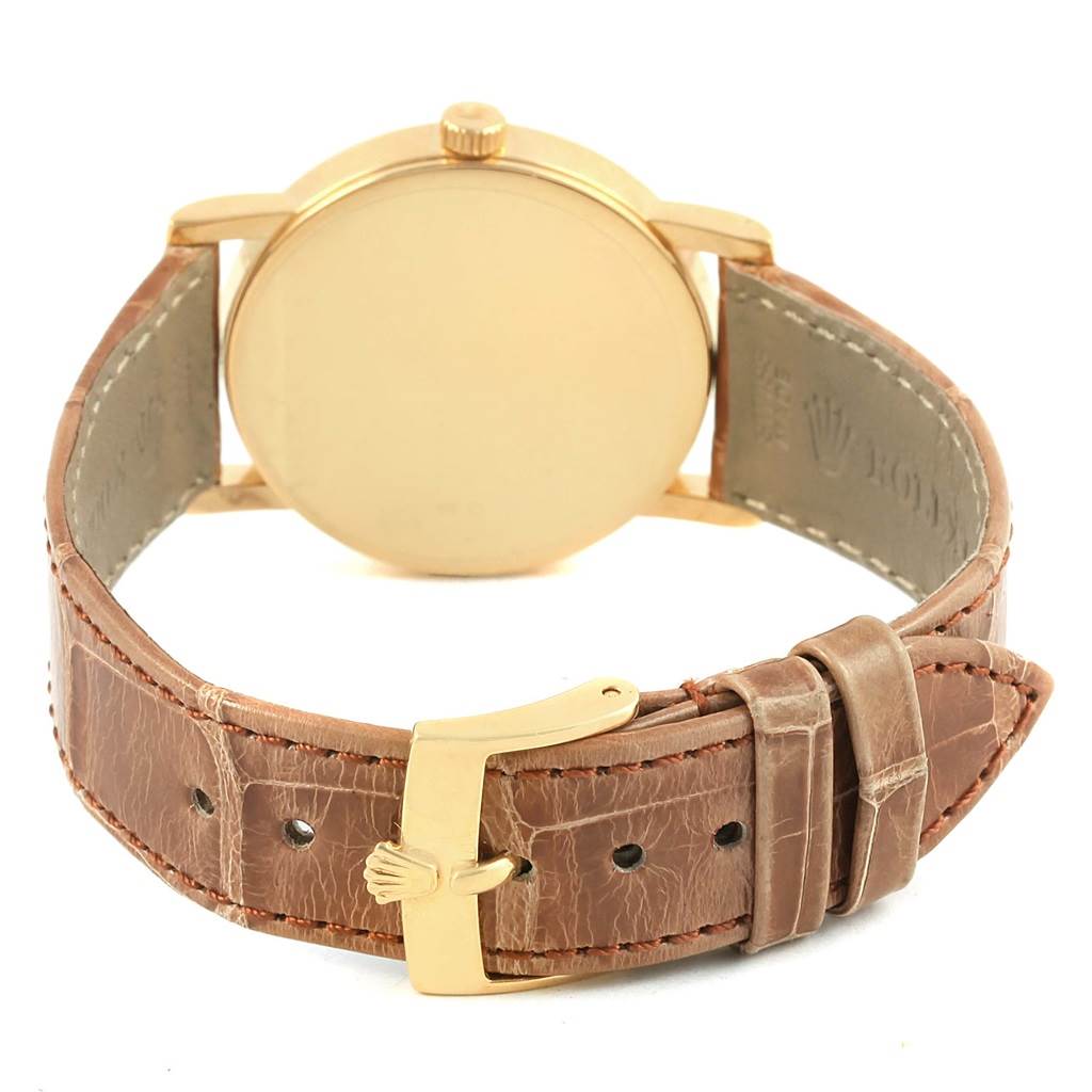 The image shows the back of the Rolex Cellini 5115 Men's Yellow Gold Beige Dial 5115 Men's Yellow Gold Beige Dial watch and its leather strap with a gold buckle.