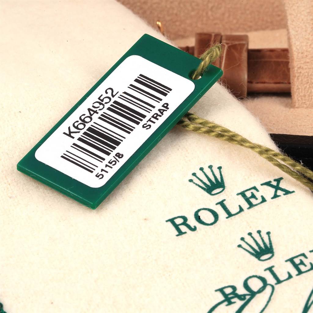 The image shows a close-up of the Rolex Cellini 5115 Men's Yellow Gold Beige Dial 5115 Men's Yellow Gold Beige Dial model watch tag and part of the strap.