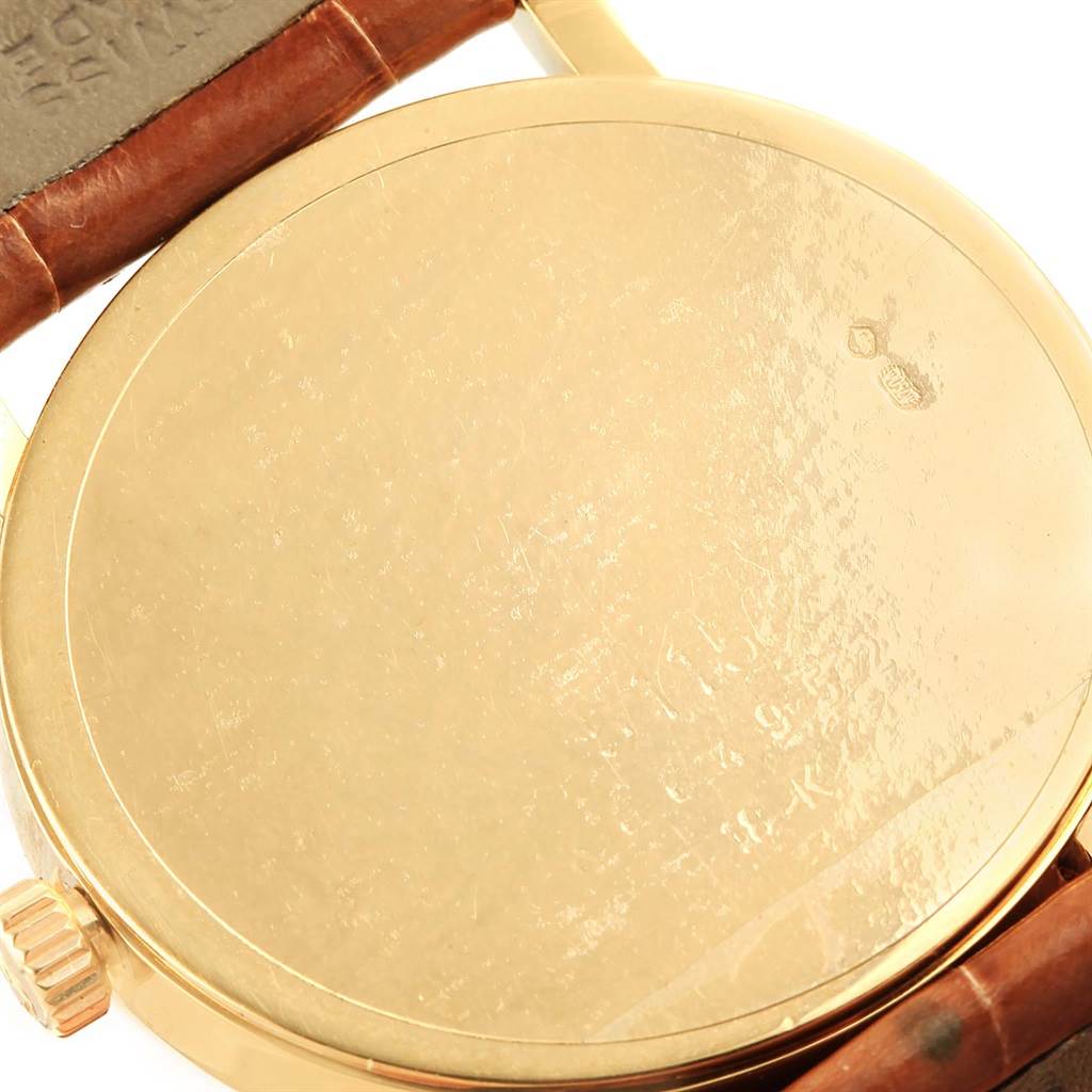 This image shows the back case and part of the leather strap of a Rolex Cellini 5115 Men's Yellow Gold Beige Dial 5115 Men's Yellow Gold Beige Dial watch at a close-up angle.
