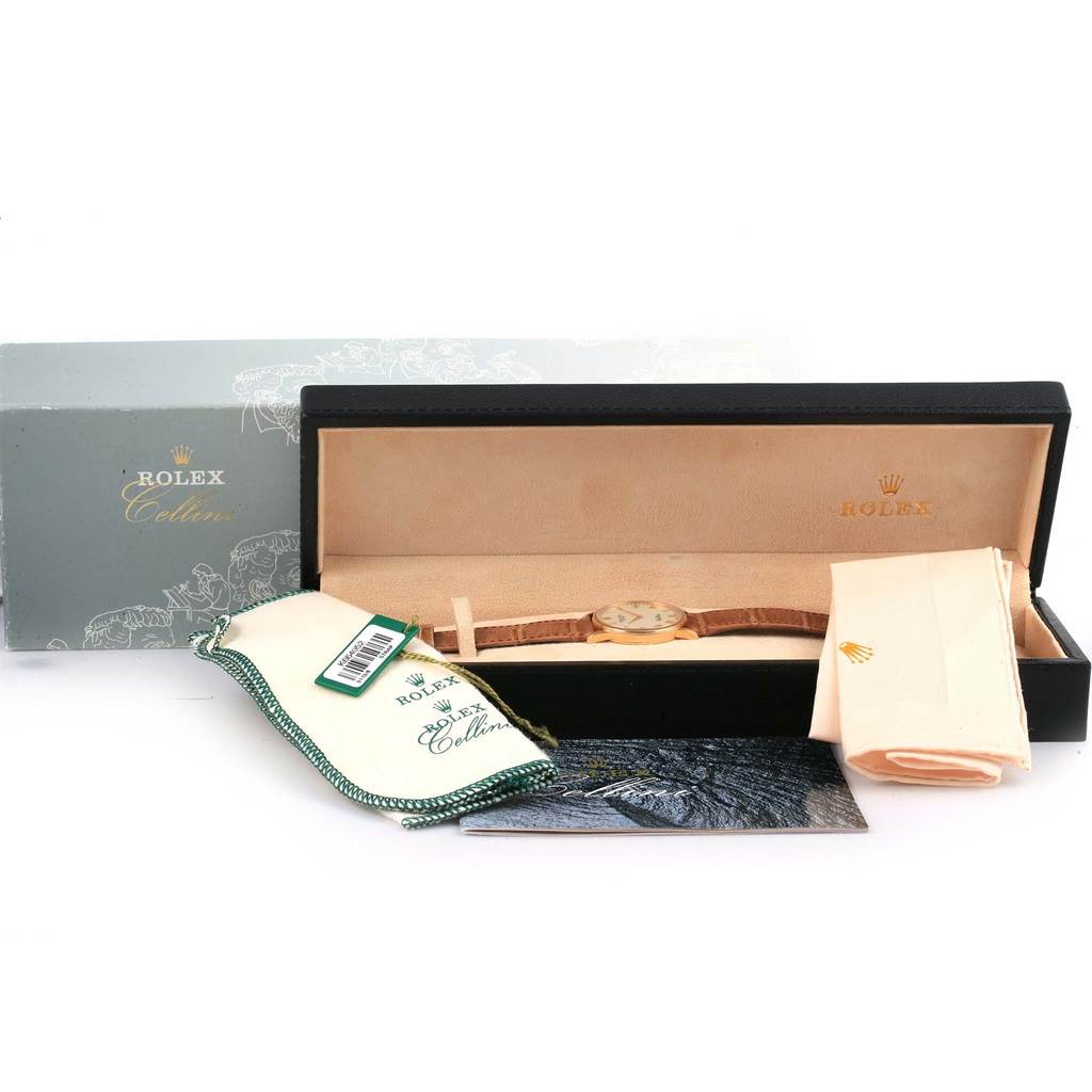 The Rolex Cellini 5115 Men's Yellow Gold Beige Dial 5115 Men's Yellow Gold Beige Dial watch is shown in its open box with accessories including a cloth and tag.