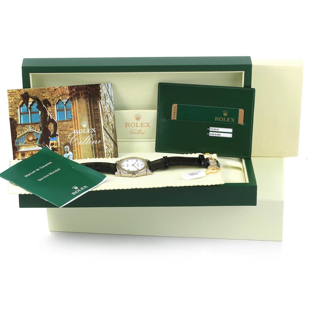 The image shows a Rolex Cellini 5330 Men
s White Gold White Dial 5330 Men
s White Gold White Dial watch and its accessories including manuals and documentation, displayed in an open box.