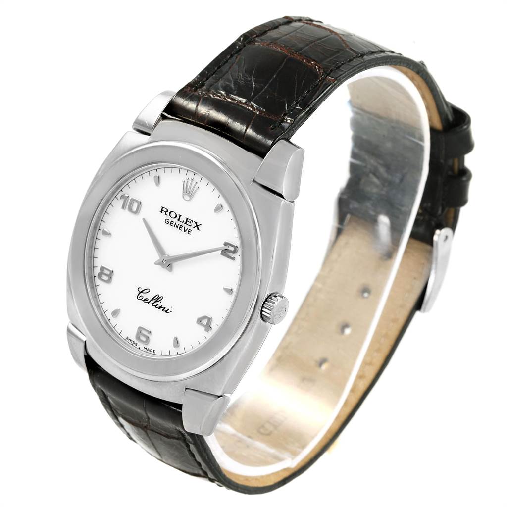 The image shows a Rolex Cellini 5330 Men
s White Gold White Dial 5330 Men
s White Gold White Dial watch at a slight angle, highlighting its white dial, silver case, and black leather strap.