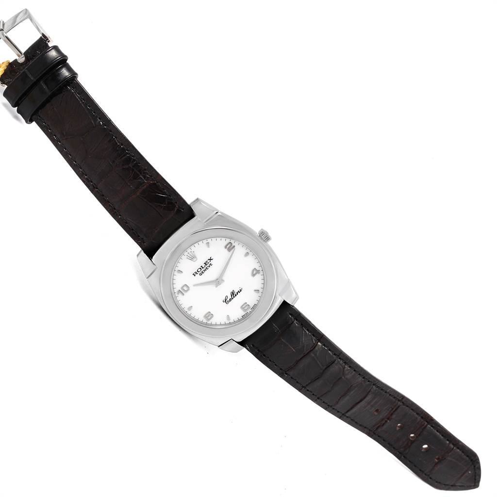 The Rolex Cellini 5330 Men
s White Gold White Dial 5330 Men
s White Gold White Dial watch is shown face-up, displaying its dial, case, and dark leather strap with a buckle.