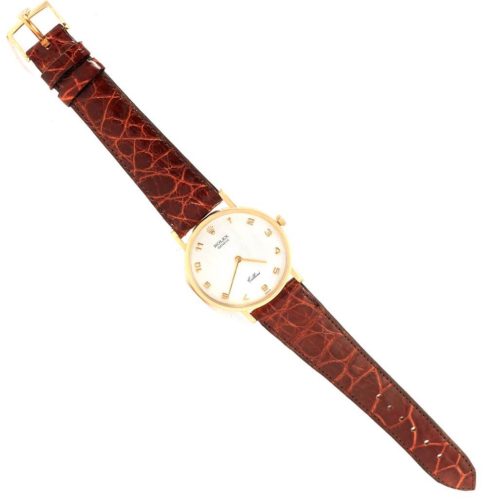 This image shows a Rolex Cellini 5112 Yellow Gold Mother of Pearl Dial 5112 Yellow Gold Mother of Pearl Dial watch, displaying a top-down view of the dial face, case, and leather strap.