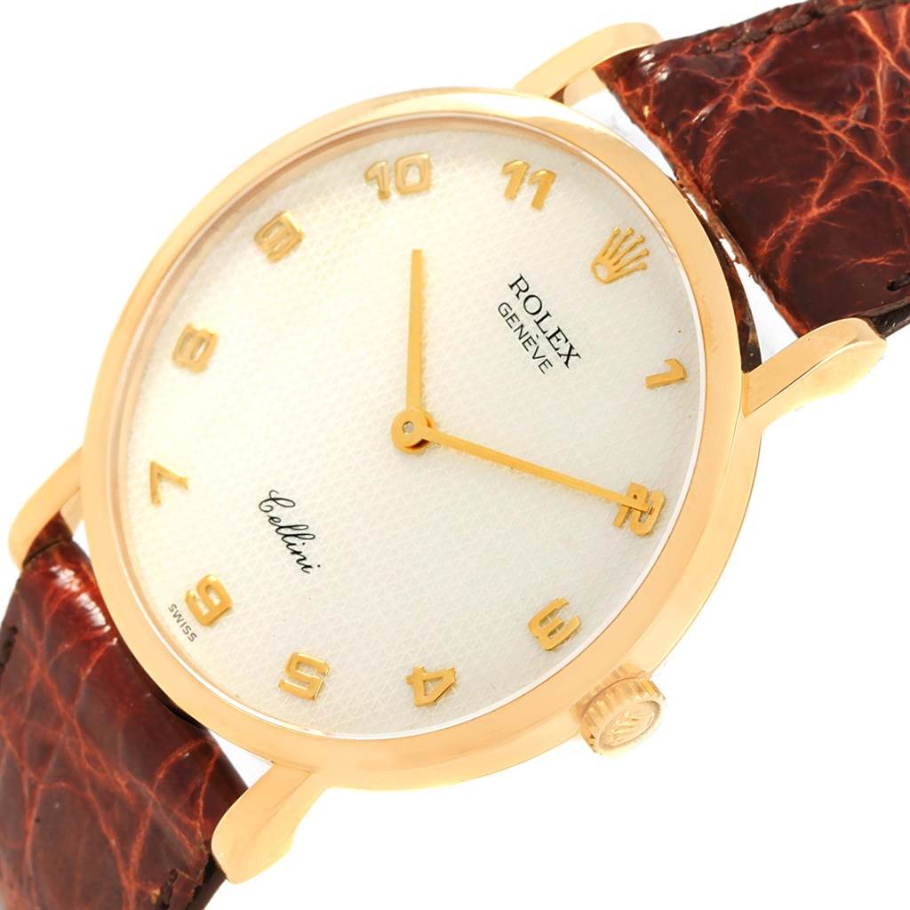 The Rolex Cellini 5112 Yellow Gold Mother of Pearl Dial 5112 Yellow Gold Mother of Pearl Dial watch is shown from a tilted angle, displaying its face, crown, and partial leather strap.