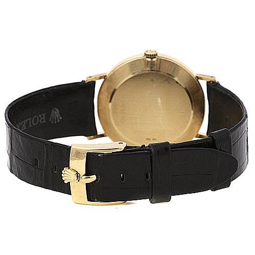 The image shows the back of a Rolex Cellini 4112 Yellow Gold Mother of Pearl Dial 4112 Yellow Gold Mother of Pearl Dial watch, highlighting the gold case, black leather strap, and gold buckle clasp.