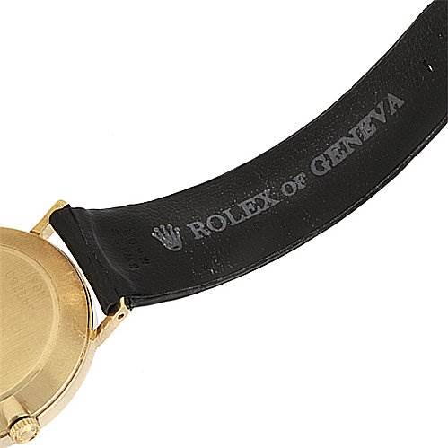 This image shows the back of the gold case and leather strap of a Rolex Cellini 4112 Yellow Gold Mother of Pearl Dial 4112 Yellow Gold Mother of Pearl Dial watch.