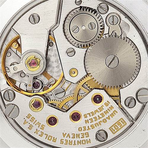 This is an image of the inner movement mechanism of the Rolex Cellini 4112 Yellow Gold Mother of Pearl Dial 4112 Yellow Gold Mother of Pearl Dial watch, showcasing gears, jewels, and intricate components.