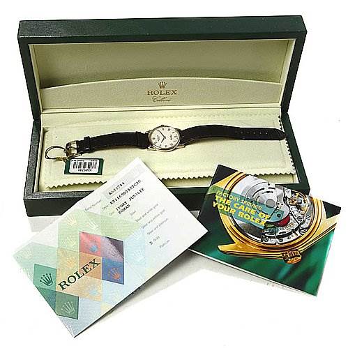 The image shows a Rolex Cellini 5116/9 White Gold Beige Dial 5116/9 White Gold Beige Dial watch from a top-down angle, inside its open box, along with booklets and a warranty card.