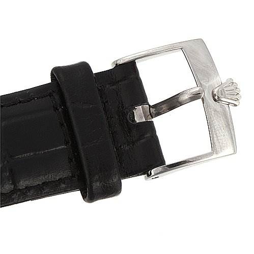 The image shows a close-up of the buckle and part of the black leather strap of a Rolex Cellini 5116/9 White Gold Black Dial 5116/9 White Gold Black Dial watch.