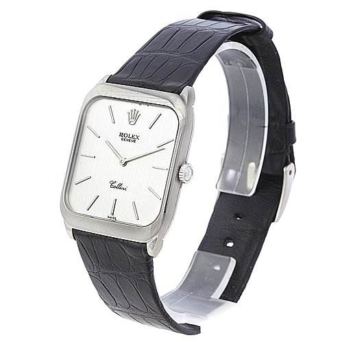 The image shows a Rolex Cellini 4135 White Gold Silver Dial 4135 White Gold Silver Dial watch from a side angle, displaying its rectangular face, leather strap, and clasp.