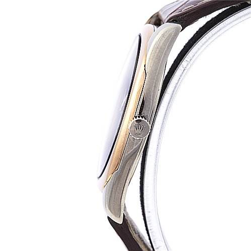 This side view of the Rolex Cellini 4233 White Gold Black Dial 4233 White Gold Black Dial watch shows the crown, case, and part of the leather strap.