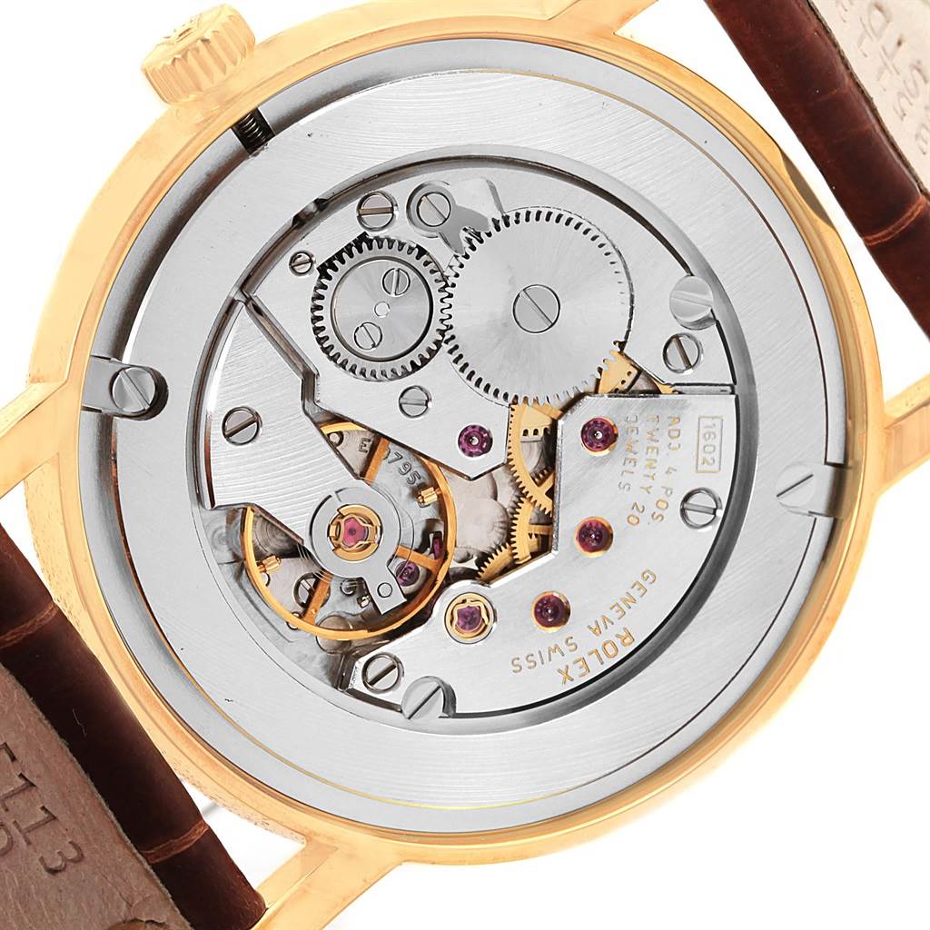 The image shows the back of a Rolex Cellini 5115 Men's Yellow Gold Beige Dial 5115 Men's Yellow Gold Beige Dial watch, highlighting its intricate mechanical movement and gears.