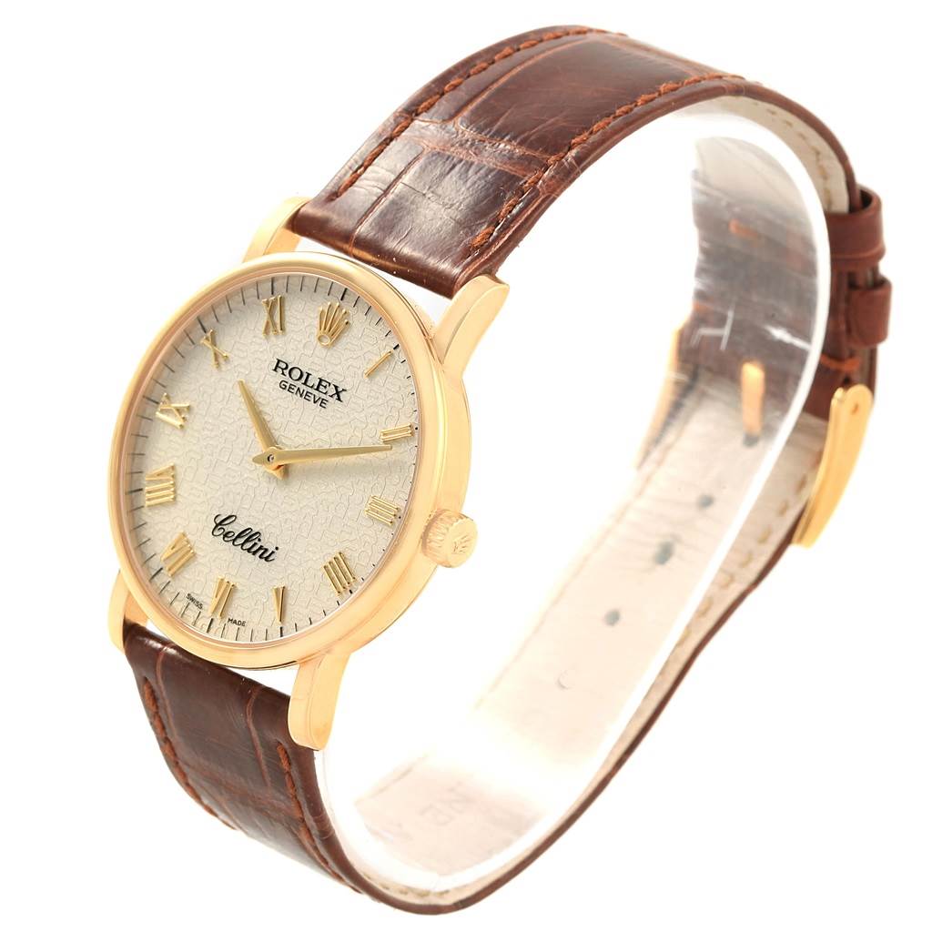 The image shows a side view of a Rolex Cellini 5115 Men's Yellow Gold Beige Dial 5115 Men's Yellow Gold Beige Dial watch, highlighting its gold case, brown leather strap, and textured dial.