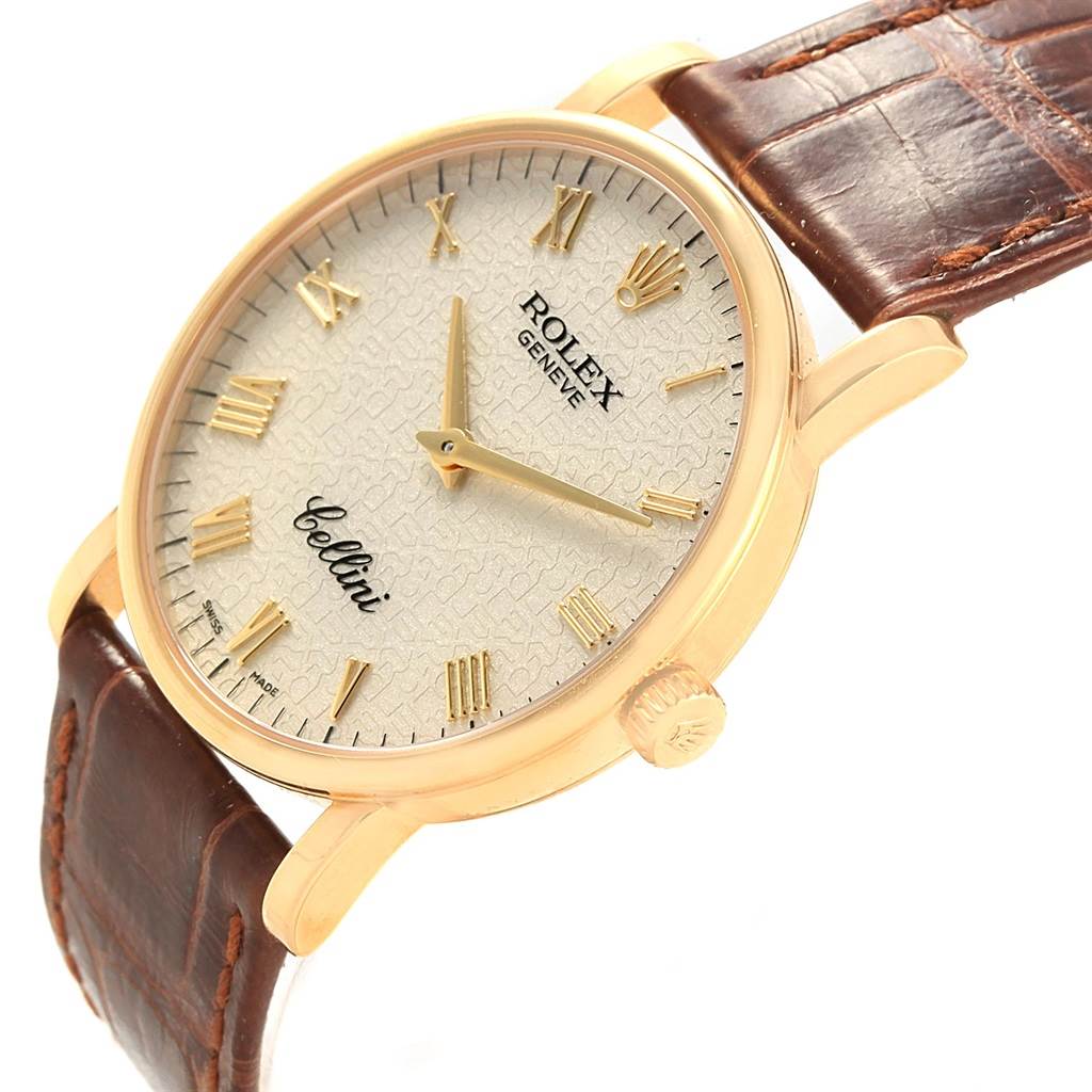 The Rolex Cellini 5115 Men's Yellow Gold Beige Dial 5115 Men's Yellow Gold Beige Dial watch is shown at a 3/4 angle, displaying the dial, crown, gold case, and brown leather strap.