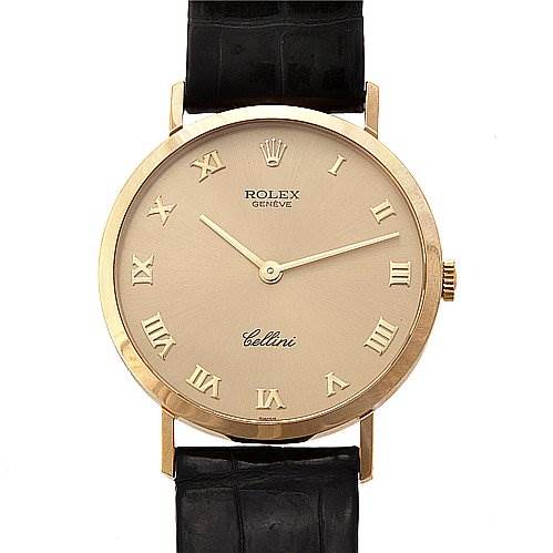 The Rolex Cellini 4112 Yellow Gold Champagne Dial 4112 Yellow Gold Champagne Dial watch is shown from a front angle, displaying its dial, hands, Roman numerals, and leather strap.