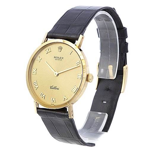 The Rolex Cellini 4112 Yellow Gold Champagne Dial 4112 Yellow Gold Champagne Dial watch is shown at an angled side view, highlighting its gold case, Roman numeral dial, and black leather strap.