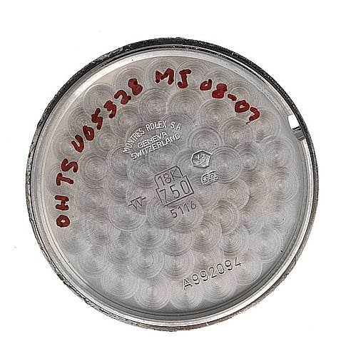 This image shows the inner case back of the Rolex Cellini 5116/9 White Gold Black Dial 5116/9 White Gold Black Dial watch model with several markings and engravings.