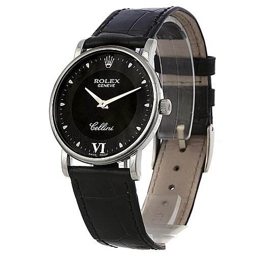 The image shows a Rolex Cellini 5115/9 White Gold Black Dial 5115/9 White Gold Black Dial watch at a slight side angle, featuring its black dial, hour markers, brand logo, and black leather strap.