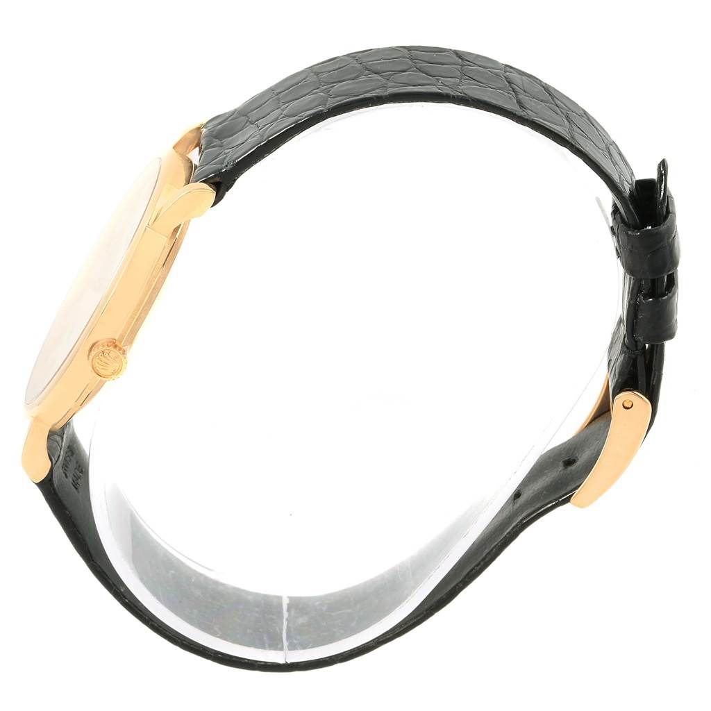 The image shows a side view of a Rolex Cellini 5112 Men's Yellow Gold Beige Dial 5112 Men's Yellow Gold Beige Dial watch, highlighting its gold case and black leather strap.