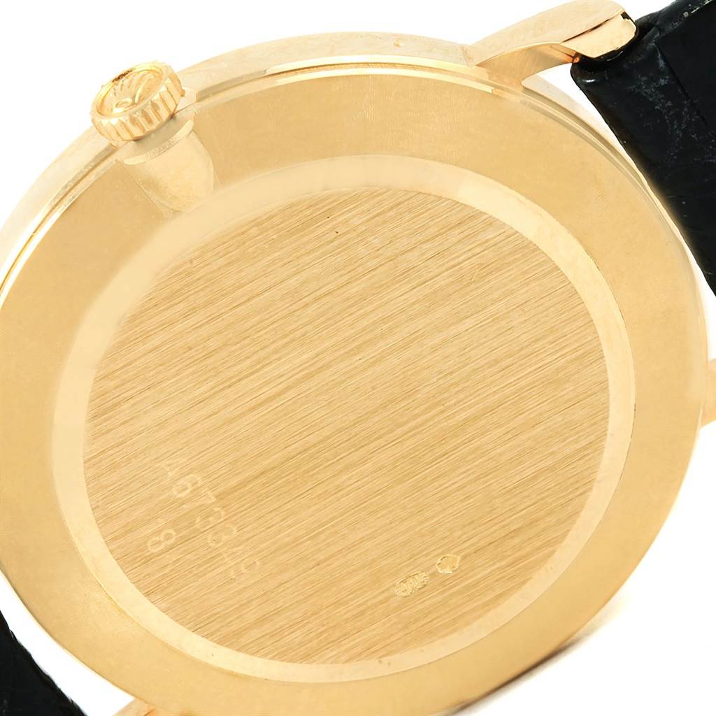 This image shows the back case of a Rolex Cellini 5112 Men's Yellow Gold Beige Dial 5112 Men's Yellow Gold Beige Dial model watch viewed from an angle where the crown and strap are partially visible.