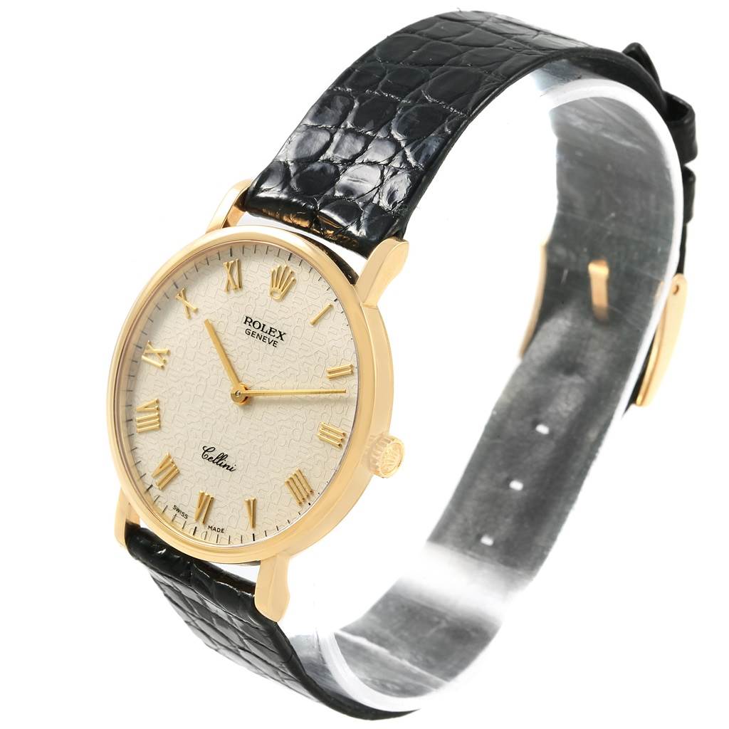 The image shows a Rolex Cellini 5112 Men's Yellow Gold Beige Dial 5112 Men's Yellow Gold Beige Dial watch at an oblique angle, highlighting its face, bezel, and black leather strap.