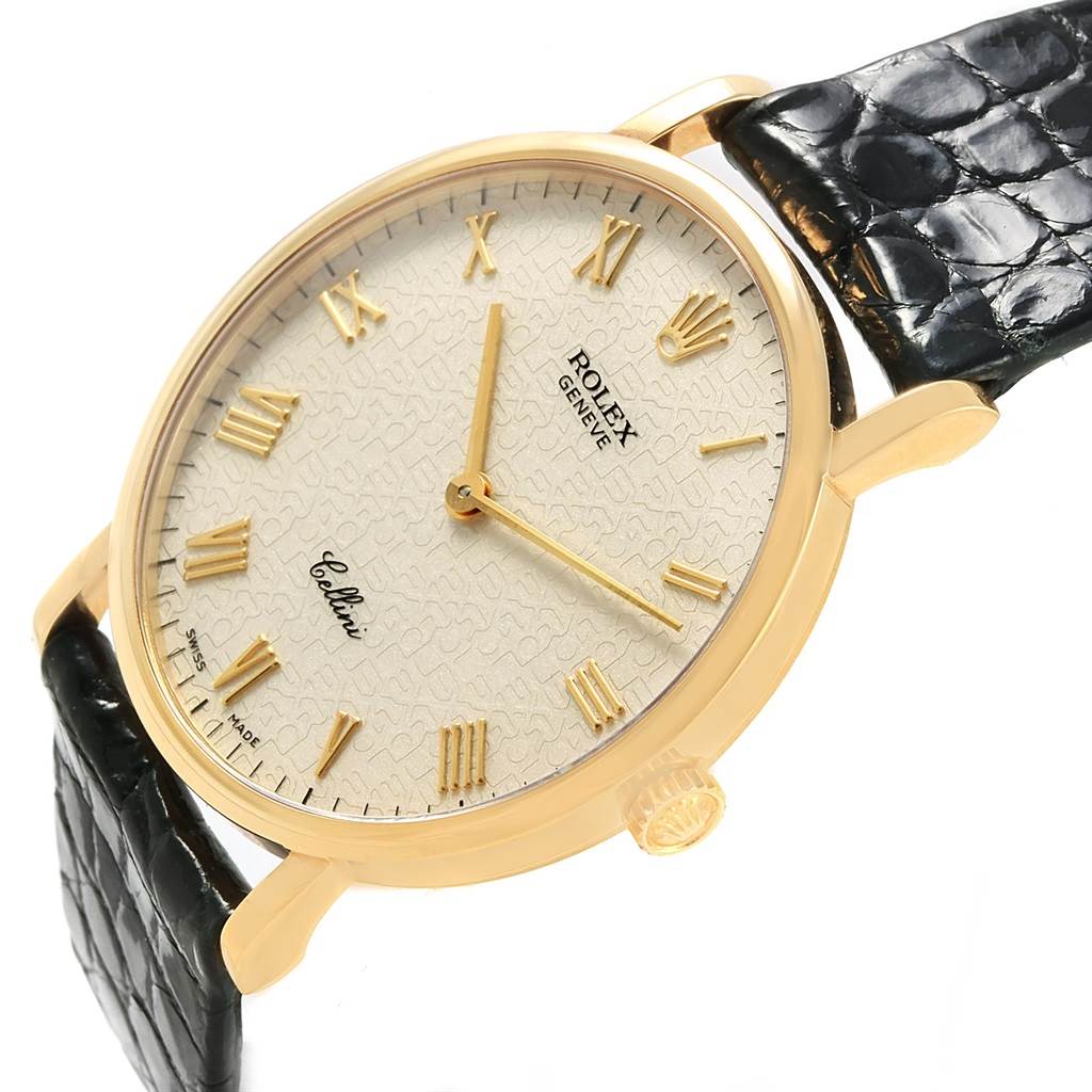 The Rolex Cellini 5112 Men's Yellow Gold Beige Dial 5112 Men's Yellow Gold Beige Dial watch is shown at an angled view highlighting the dial, Roman numerals, crown, and black leather strap.