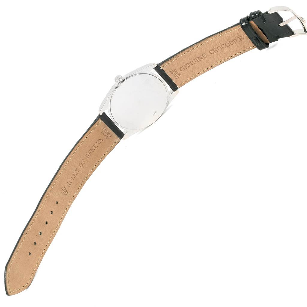 The image shows the back view of a Rolex Cellini 4233 Men's White Gold Black Dial 4233 Men's White Gold Black Dial watch, displaying its case back and genuine crocodile leather strap.